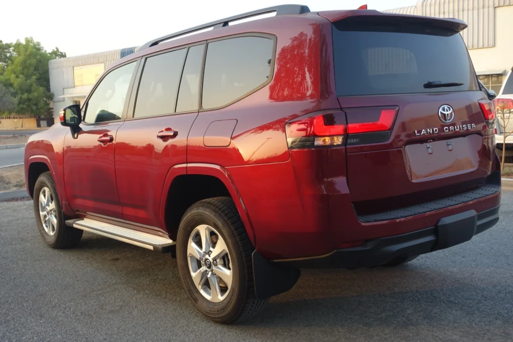 This image has an empty alt attribute; its file name is TOYOTA-Land-Cruiser-300-Red-back-view-left-angle-1024x682.webp