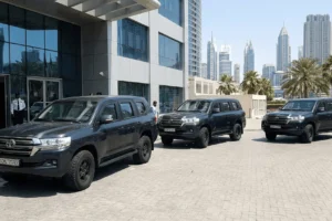 Armored Toyota Land Cruiser SUVs parked outside a modern facility in Dubai schutzcarr