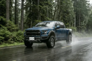 Ford Raptor driving at speed on a rainy forest highway schutzcarr