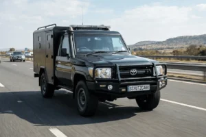 a black Toyota Land Cruiser 79 cash in transit driving on the highway