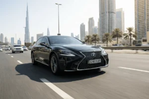 a black luxury lexus sedan in transit driving on the highway in dubai