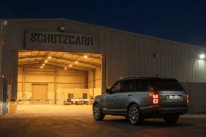 range rover vogue parked outside schutzcarr warehouse at night
